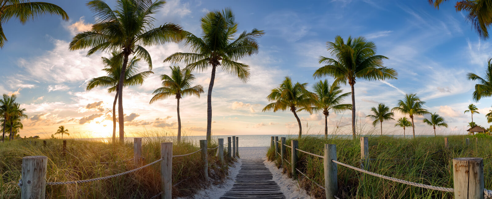 Anna Maria Island beach boardwalk at golden sunset — retirement and life insurance planning for AMI and Holmes Beach residents
