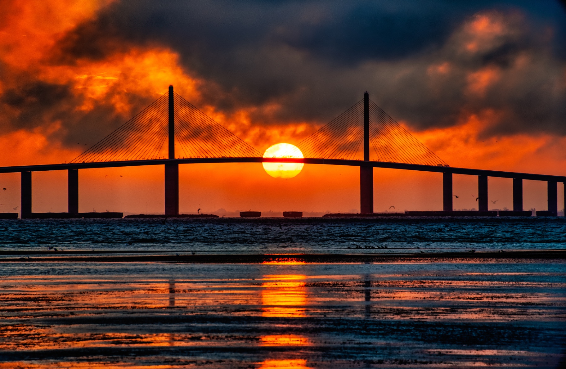 Sunshine Skyway Bridge at fiery sunset over Tampa Bay near Tierra Verde, Florida